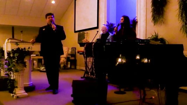 Pastor Vaughn with the First Harvest Music Ministry sings  There Is A River  during a LIVE service