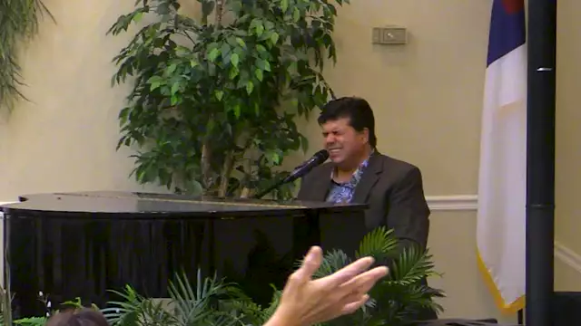 Pastor Vaughn at the Piano singing 